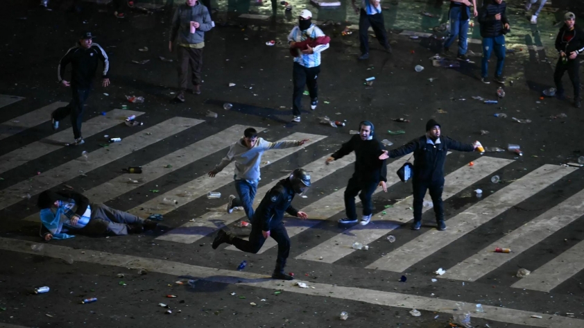 riot-police-officer-runs-strikin