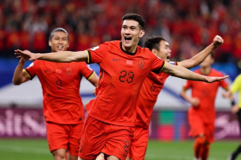 qingdao-china-october-15-behram-abduweli-of-china-celebrates-after-scoring-his-teams-first-1729001653034