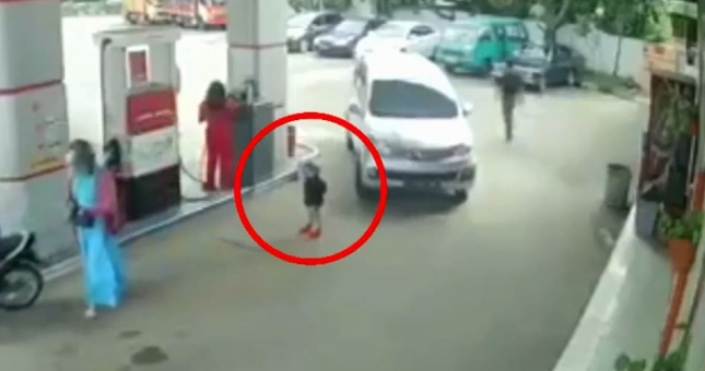 'Hú hồn' em bé bị cuốn vào gầm xe tải khi đứng chờ đổ xăng